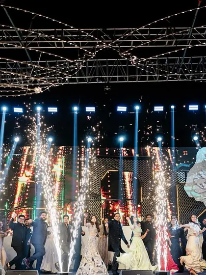 This is how we end a sangeet night, with a grand finale that brings everyone together. This shot captures the explosive energy of a full-family performance, complete with perfectly timed pyrotechnics that light up the stage and create a memory for a lifetime.
