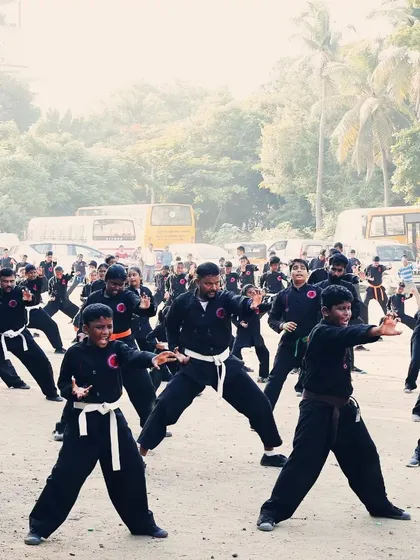 Students execute a synchronized form during a combined belt test. Notice the focus and shared energy, which is a hallmark of our group training method.