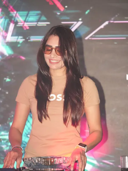 A happy, smiling shot of me at the console at Ibiza Jhansi. My genuine enjoyment of the music is a key part of the positive vibe I bring to every event.
