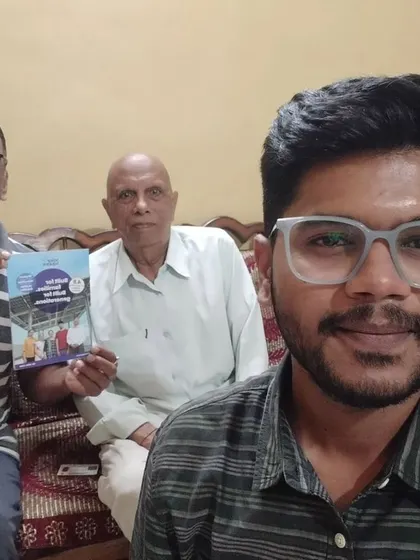 Our team takes a selfie with two new customers holding our solar guide.