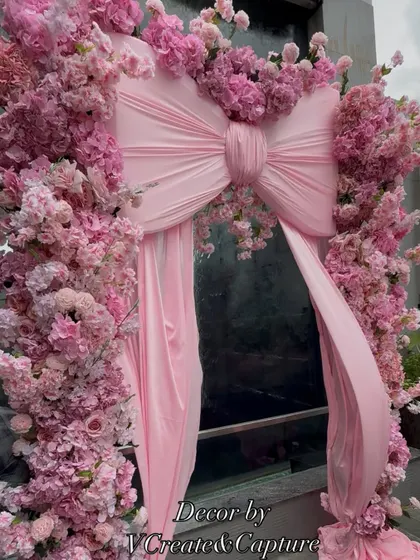 The magnificent pink bow and floral arch, a perfect statement piece for an entrance or photo booth.