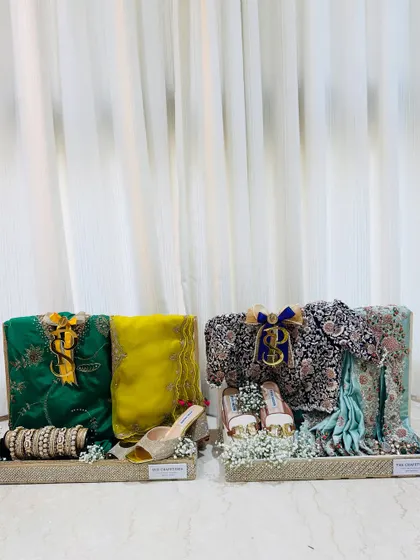Two trousseau trays, side-by-side. Each one is a work of art, styled to reflect the bride's personality and the spirit of the occasion.