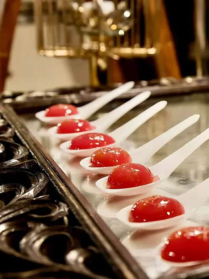 My molecular gastronomy desserts are designed to surprise. These rose-flavored spheres burst in your mouth, releasing a floral, sweet liquid for a truly unique gastronomic adventure.