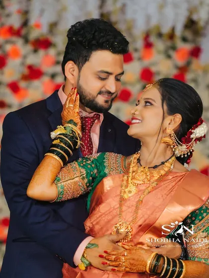 A playful and romantic reception photo. Shilpa's makeup is a mix of traditional and modern, with a beautiful saree and glowing skin.