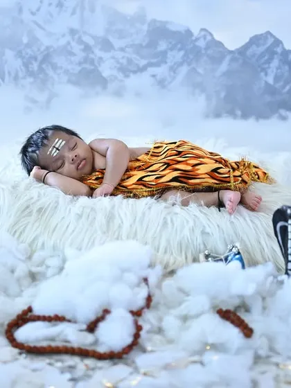 For the festival of Mahashivaratri, I designed this divine 'Bala Shiva' theme. Here, the newborn is sleeping peacefully on a cloud-like bed with a backdrop of the Himalayas, complete with a miniature trishul and damaru.