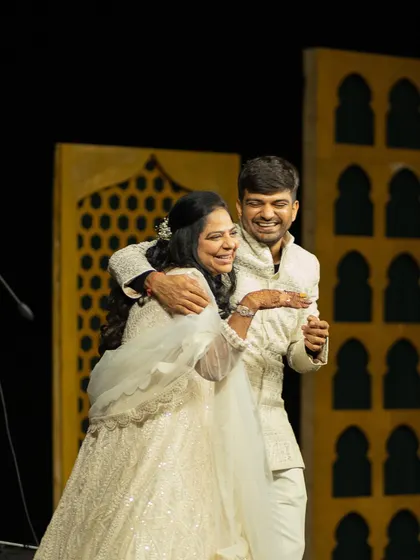The brother of the bride shares a dance with his sister. For the sangeet, we styled him in a custom ivory sherwani that was both regal and comfortable for a night of performances.