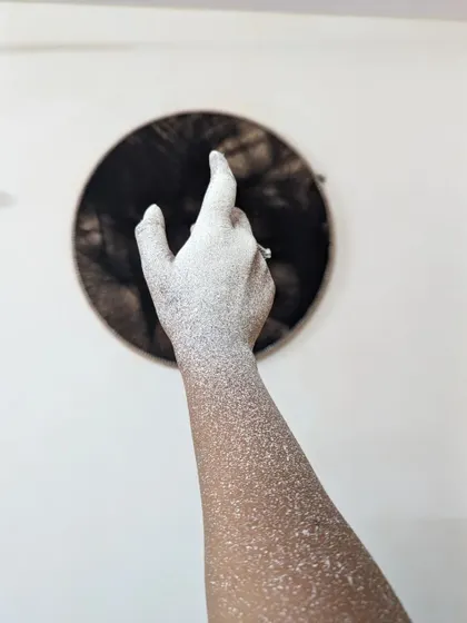 A simple, happy moment of creating. My arm covered in white paint speckles is a testament to the physical, hands-on nature of painting large walls and bringing a vision to life.