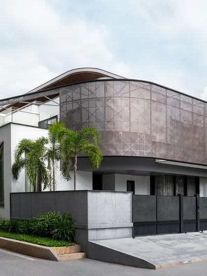 For the Juneja Residence, we designed a unique perforated metal screen that wraps around the upper floor. This architectural element provides privacy and shade from the western sun while creating a dynamic, modern facade that makes a bold statement.