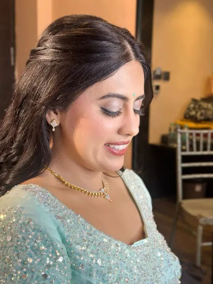 A candid moment of laughter. The makeup is designed to look beautiful and natural, even in motion.