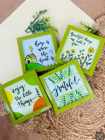Our 'Green Quoted Combo' is perfect for adding a touch of nature and positivity to your home. This image shows the four green glass frames included in the set, each with a unique hand-doodled design.