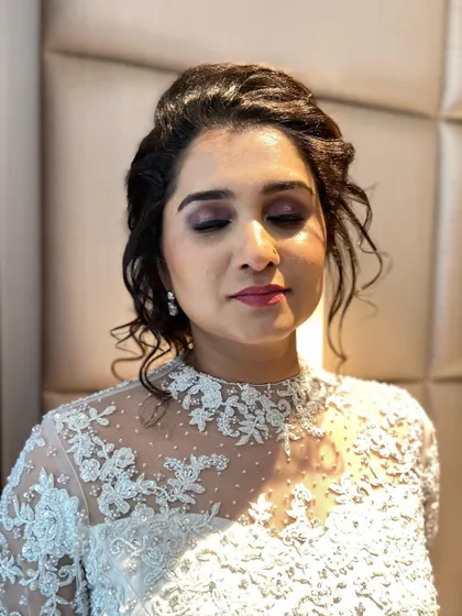 A shot with her eyes closed, showcasing the soft, shimmery eyeshadow that adds a touch of romance to the look.