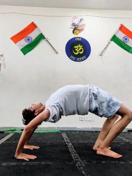 Another one of our members practicing the wheel pose. The progress in flexibility and strength comes from consistent practice.