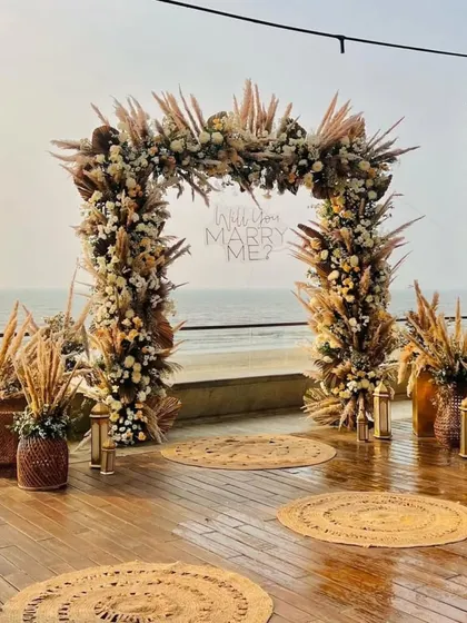 Another perspective of the proposal setup, showing the arrangement of jute rugs and lanterns leading to the main arch. Every detail is planned to build up the perfect moment.