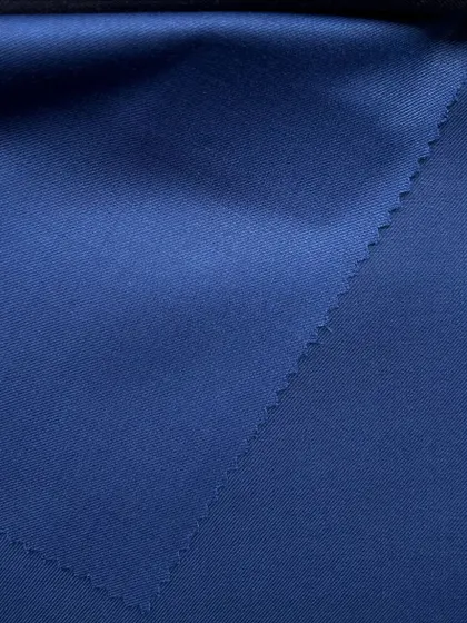 The deep, rich color of a blue wool suiting fabric, perfect for a powerful and elegant garment.