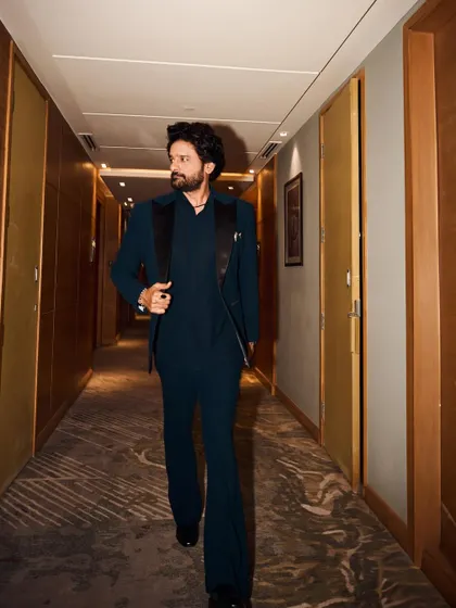 A shot that captures the suit in motion. The movement shows the quality of the tailoring and the fabric.