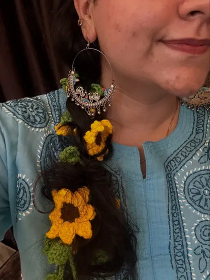 A close-up of my sunflower parandi, styled with a beautiful traditional earring. This shows how you can mix and match accessories for a complete festive look.