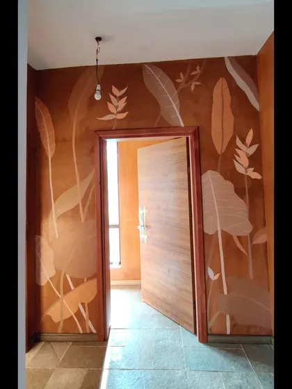 This entryway mural uses a monochrome palette on a terracotta wall to welcome you into the home.