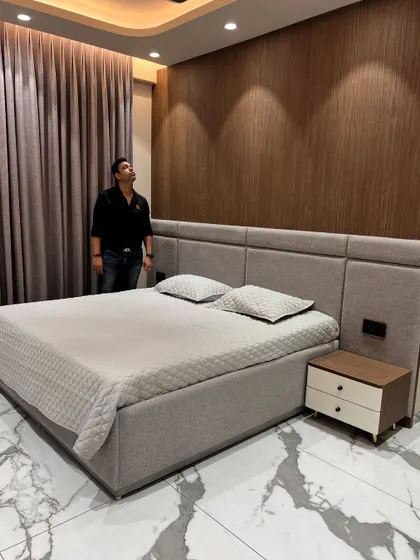 The full view of the bed and feature wall, showcasing a simple yet sophisticated modern bedroom design.