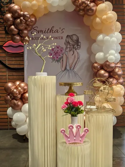 A stylish "Bride to be" party with a modern balloon arch in metallic tones and a personalized backdrop.