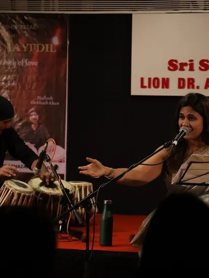 The artist interacting with the audience during the show. These moments of connection between the performer and the listeners are what make our live music events so special and engaging.