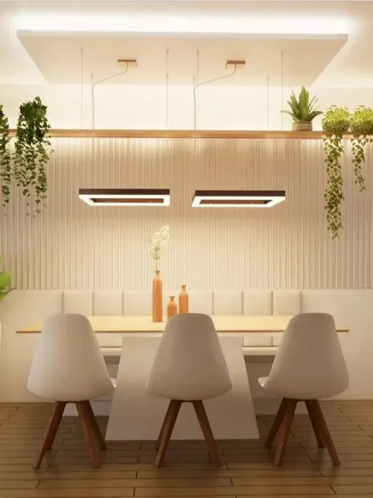 A front view of the dining setup with bench seating, highlighting the symmetry and clean lines of the furniture and lighting.