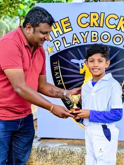 Celebrating the next generation of talent. A young player from our U-10 team receives his trophy, beaming with pride after a successful tournament.