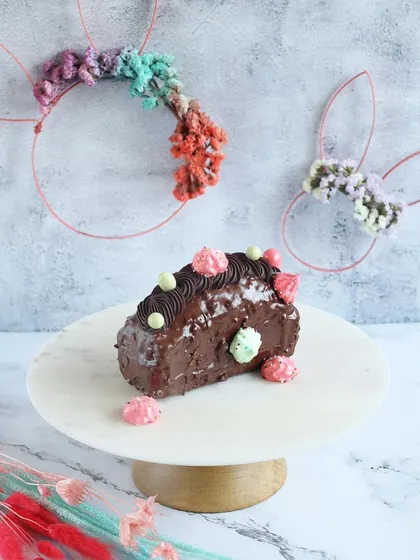 Our Easter chocolate log cake is a rich and decadent treat. It's covered in chocolate ganache and decorated with colorful mini meringues.