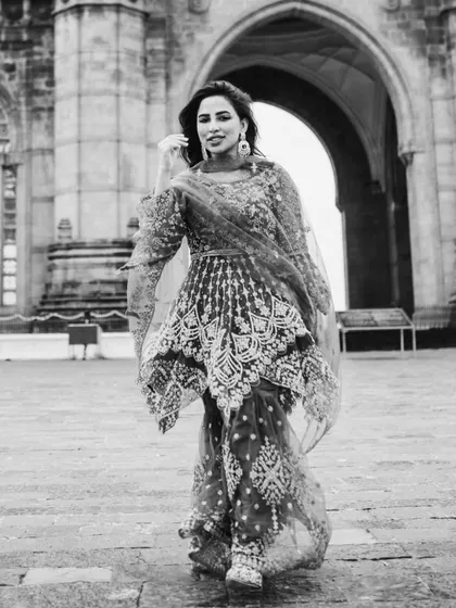 Another dynamic black and white shot, capturing her in motion. This walking pose feels confident and powerful.