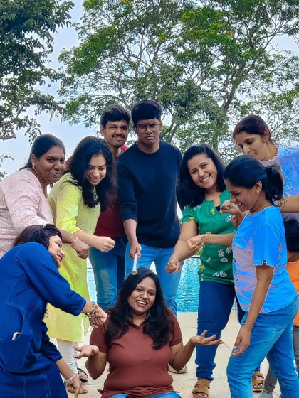 It's all fun and games. A candid shot of a team-building activity that's all about laughter and working together, set against the backdrop of a resort pool.