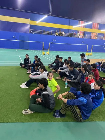A team session on the sidelines. I believe in fostering a strong team spirit and ensuring players are mentally prepared and focused before they step onto the court.