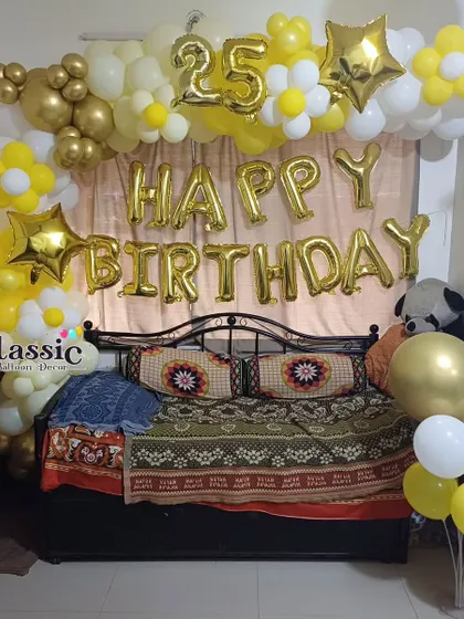 A bright and cheerful 25th birthday decoration for a bedroom, using a yellow and white balloon arch with daisy accents.