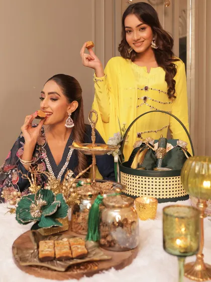 Enjoying the fruits of my labor with a friend. Our festive table is laid out with a variety of my creations, from traditional sweets to savory snacks, all ready to be shared and enjoyed.