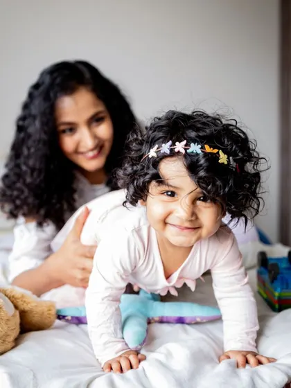 This little one's gorgeous curls and happy smile are just too adorable. I make sure to capture all the little details, like the cute butterfly clips in her hair.