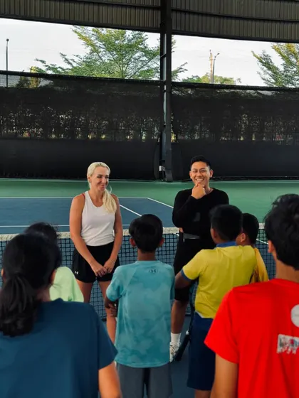 A candid moment of interaction between visiting pro Diana Marcinkevica, our coach, and a group of young, aspiring players.