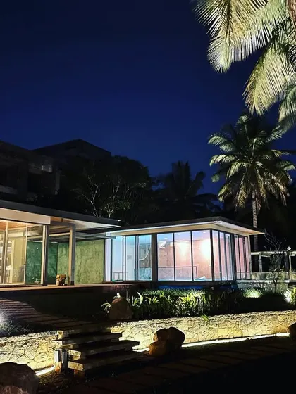 We use lighting to create a visual journey, drawing the eye from the illuminated stone wall in the foreground to the lit-up house in the background.