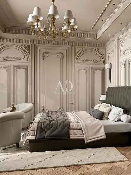 I designed this retreat to reflect opulence and luxury with exquisite detailing. The tall, channel-tufted headboard in dark leather makes a bold statement against the intricately paneled walls.