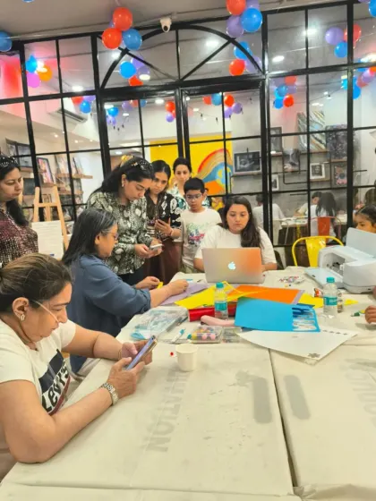 A wider shot of the bustling Cricut workshop, filled with participants of all ages enjoying a creative session together.
