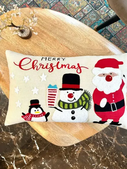 Our festive Christmas cushion cover featuring Santa, a snowman, and a penguin. Made with high-quality materials, it's sure to bring the holiday spirit to your living room.