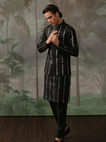 A black waistcoat set with vertical stripes of mirror work, creating a sleek and contemporary look.