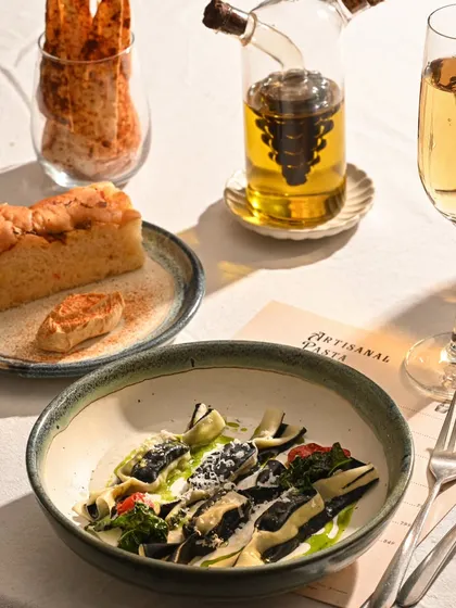 A plate of my artisanal pasta, served with fresh focaccia and olive oil. It's simple, elegant, and incredibly delicious.