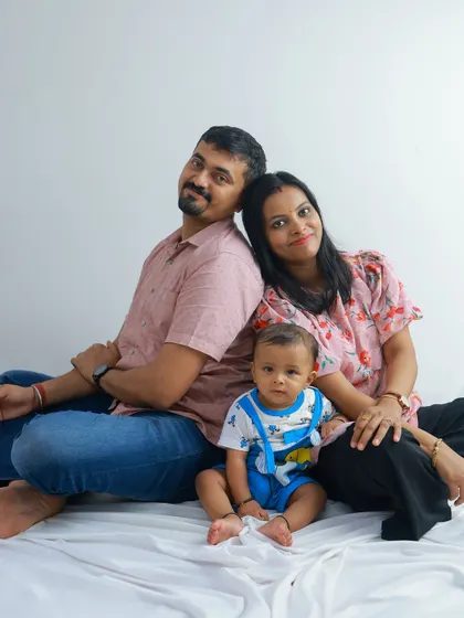 Another variation of the seated family portrait, this time with the baby crawling forward. It adds a touch of playful energy to the classic pose.