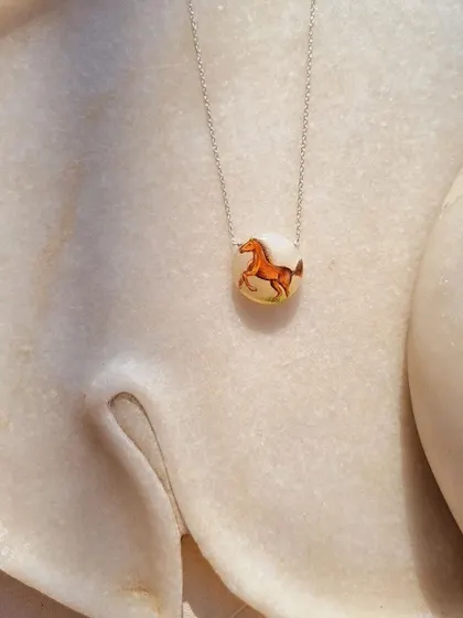 The 'Oliver's horse' pendant, a beautiful piece for abundance and emotional stability.