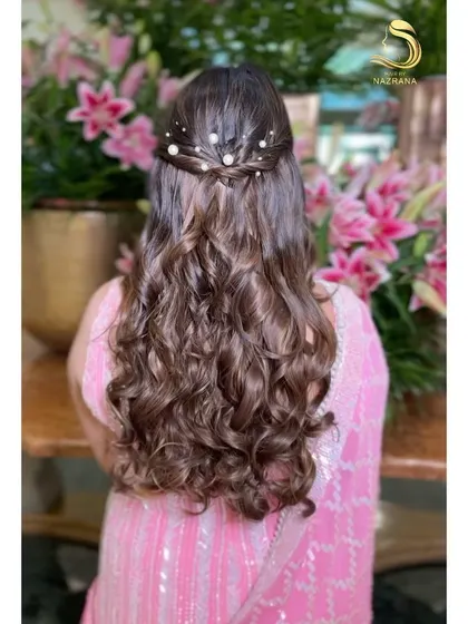 The back of this elegant half-updo, showing the twisted detail and scattered pearls.
