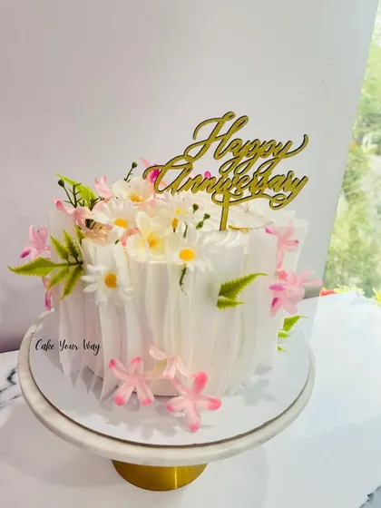Celebrating life’s sweetest moments with an elegant wafer paper and floral anniversary cake.