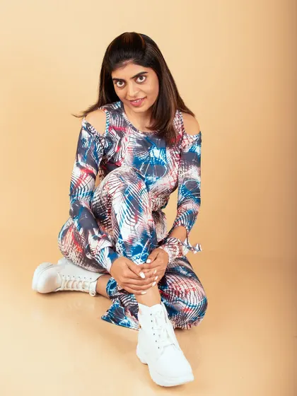 A modern studio portrait with a fun, patterned outfit and white boots. This look is perfect for a fashion blog or social media content.