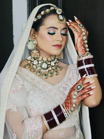 A beautiful pose showcasing the bride's intricate henna, nails, and the full effect of her makeup.