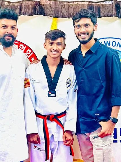 This student is proud of his new red and black belt.