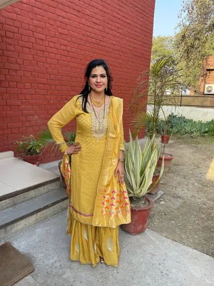 A yellow sharara suit I designed from fabric. The neckline has delicate embroidery, and the matching sharara pants create a cohesive and celebratory look.