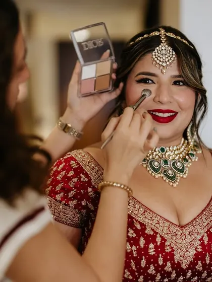 A behind the scenes shot of me applying a touch of blush. It's all about creating that natural, happy flush.