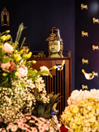 A beautiful shot from our styling workshop, showing how traditional artifacts like this brass Vishnu head can be integrated into modern decor. The juxtaposition with fresh flowers creates a stunning visual.